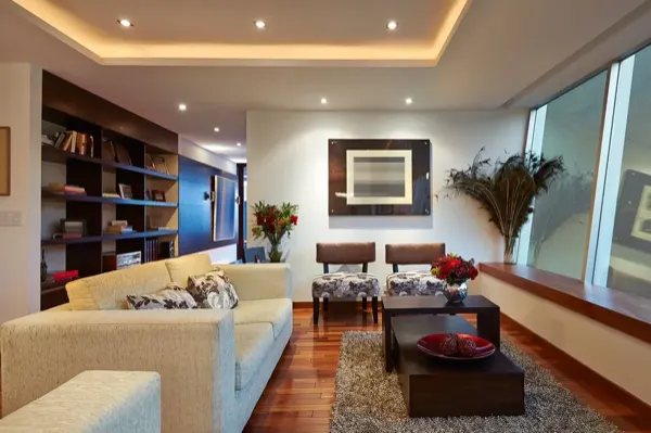 Furnished living room with sofa, rug and large window